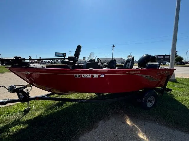 Slide: The Image of Red 2022 Lund 1675 Adventure SS boat on trailer, parked outdoors. - 4