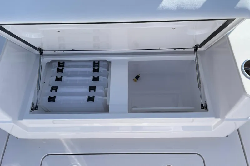 Slide: The Image of Open storage compartment on 2023 Southport 33 FE boat with organized trays. - 13