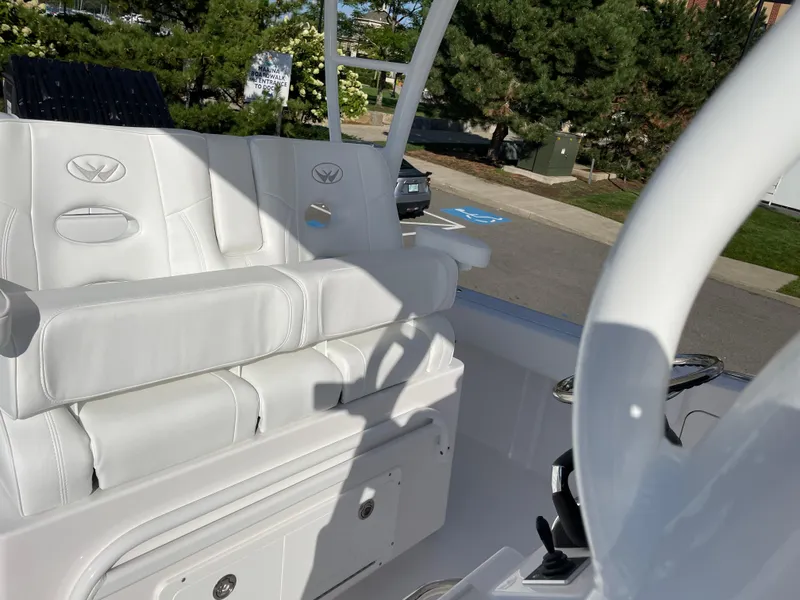 Slide: The Image of 2023 Southport 33 FE boat interior with white seating and steering wheel. - 6