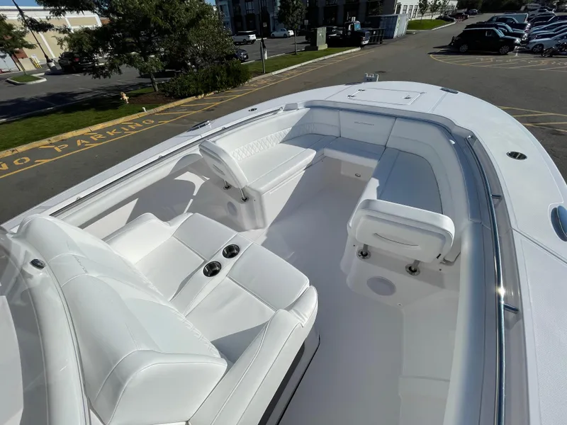 Slide: The Image of 2023 Southport 33 FE boat interior with white seating and cup holders. - 9