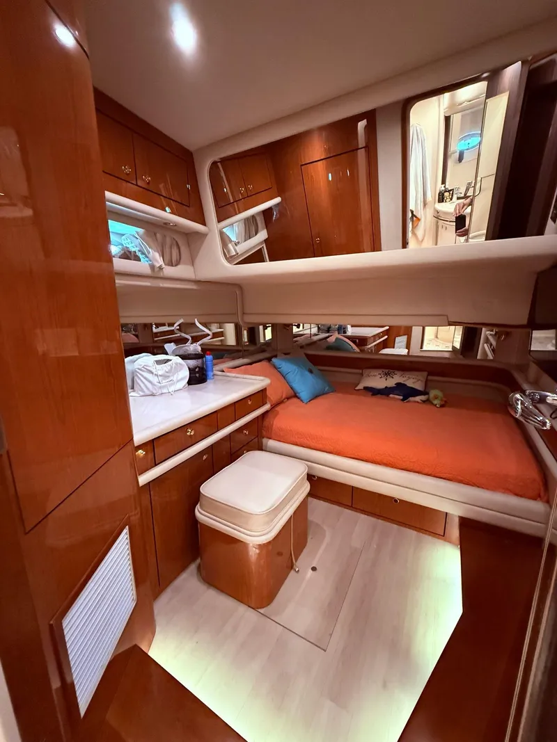 Slide: The Image of Interior cabin of 2000 Sea Ray 560 Sedan Bridge yacht with wooden furnishings and cozy bed. - 30