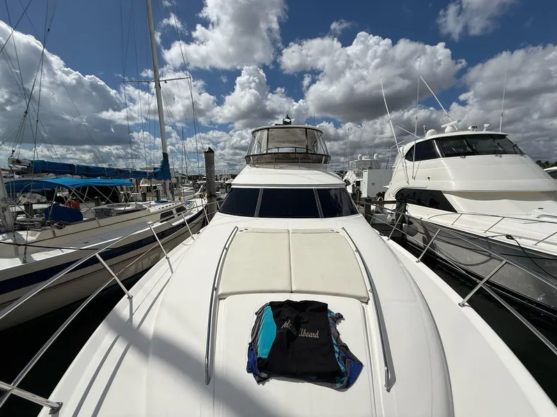 Slide: The Image of 2000 Sea Ray 560 Sedan Bridge yacht docked at marina under cloudy sky. - 6