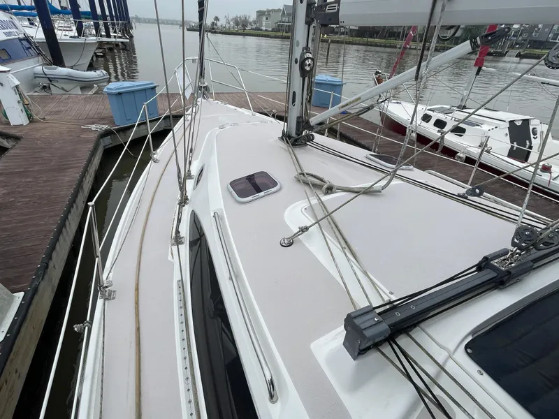 Slide: The Image of Catalina 309 sailboat deck, 2008 model, docked at marina with visible rigging and hatch. - 12