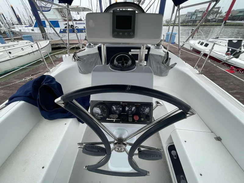 Slide: The Image of Cockpit of 2008 Catalina 309 sailboat with steering wheel and navigation instruments. - 16