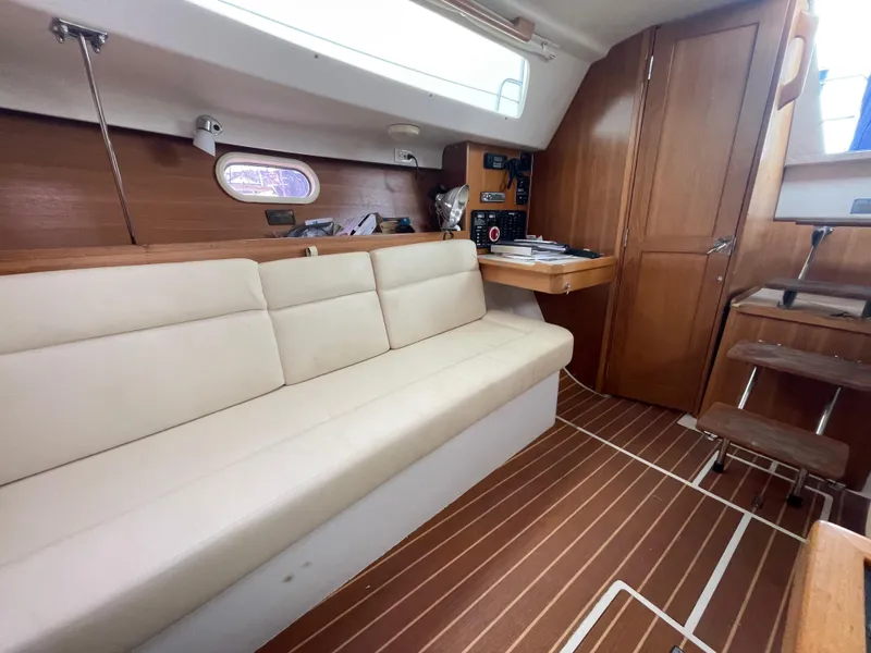 Slide: The Image of Interior of a 2008 Catalina 309 sailboat with beige seating and wooden accents. - 21