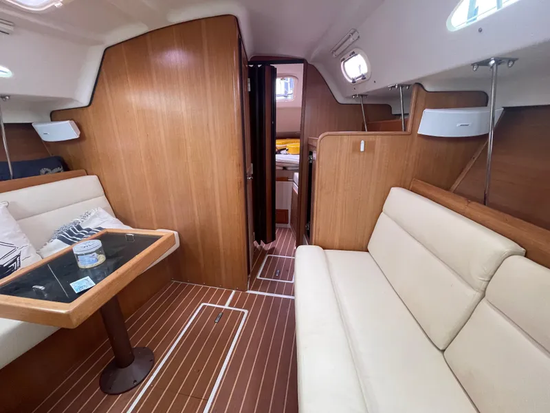 Slide: The Image of Interior of 2008 Catalina 309 sailboat with wood paneling and comfortable seating. - 22