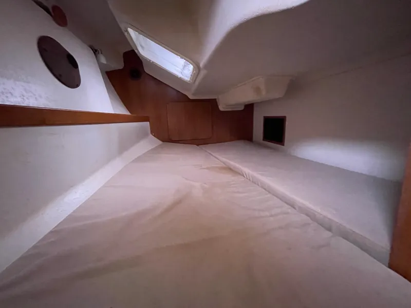 Slide: The Image of Interior cabin of a 2008 Catalina 309 sailboat, featuring a cozy sleeping area. - 24