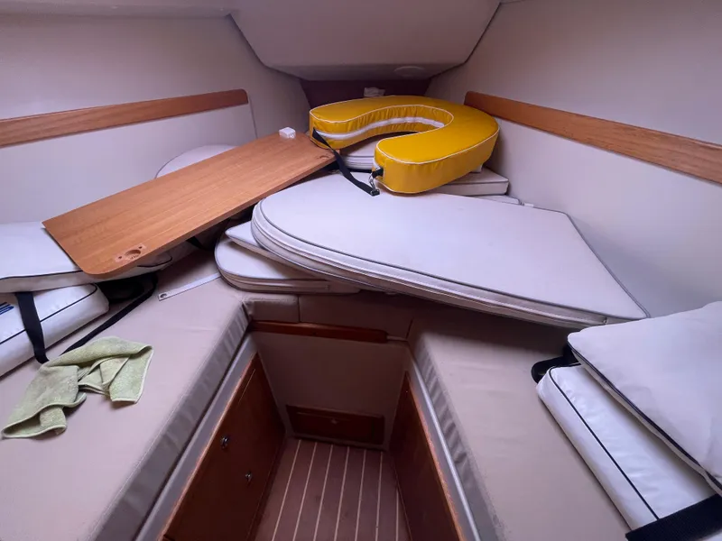 Slide: The Image of Interior cabin of 2008 Catalina 309 sailboat with cushions and table. - 27