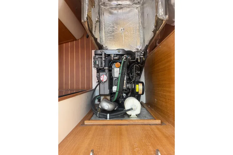 Slide: The Image of Engine compartment of a 2008 Catalina 309 sailboat, showcasing mechanical components and insulation. - 31