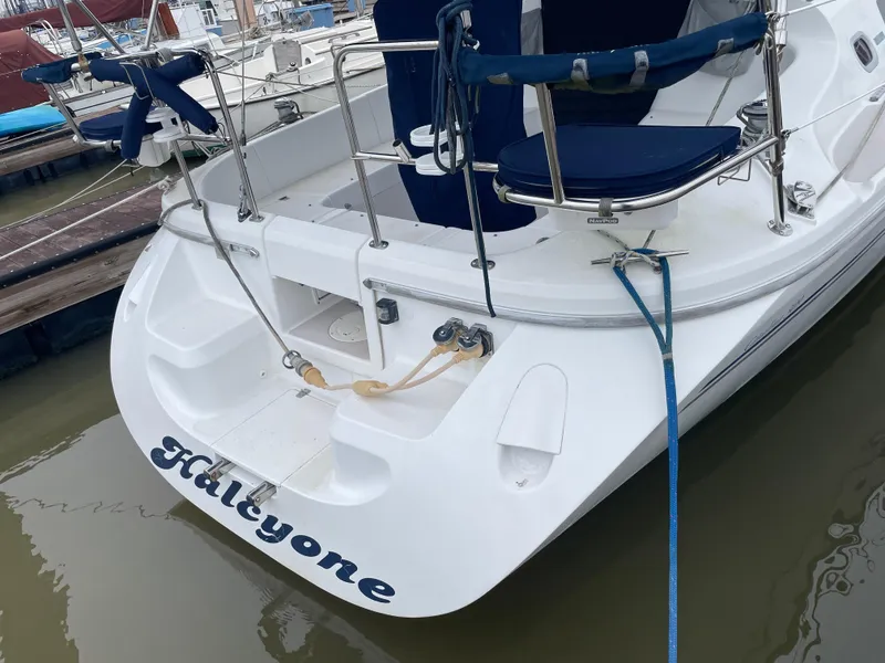 Slide: The Image of Catalina 309 sailboat, 2008 model, docked with blue seating and visible name "Halleyone". - 7