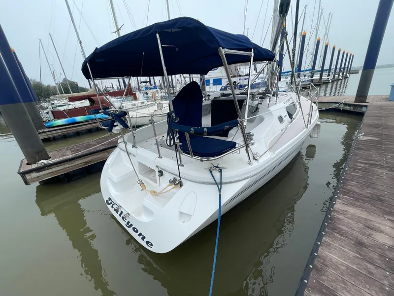 Slide: The Image of 2008 Catalina 309 sailboat docked at marina with blue canopy. - 9