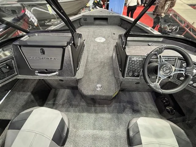 Slide: The Image of 2025 Crestliner 1850 Fish Hawk WT JS boat interior with steering wheel and seating. - 10