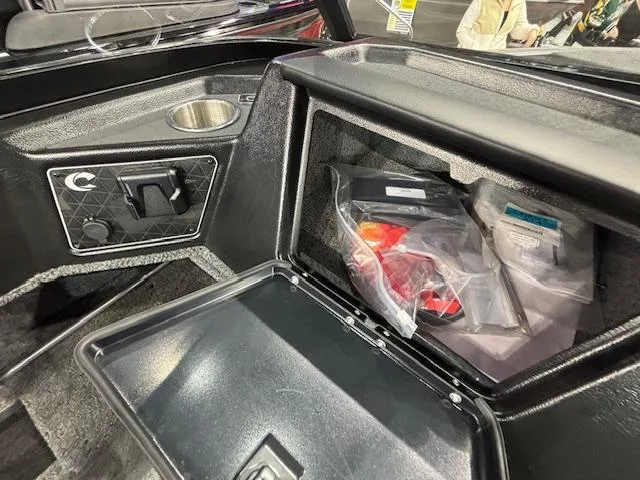 Slide: The Image of 2025 Crestliner 1850 Fish Hawk WT JS boat storage compartment with accessories and cup holder. - 13