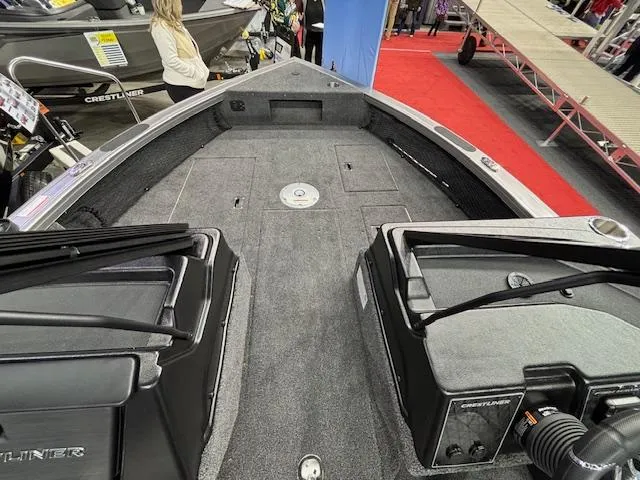 Slide: The Image of 2025 Crestliner 1850 Fish Hawk WT JS boat interior at a show, featuring spacious deck. - 14