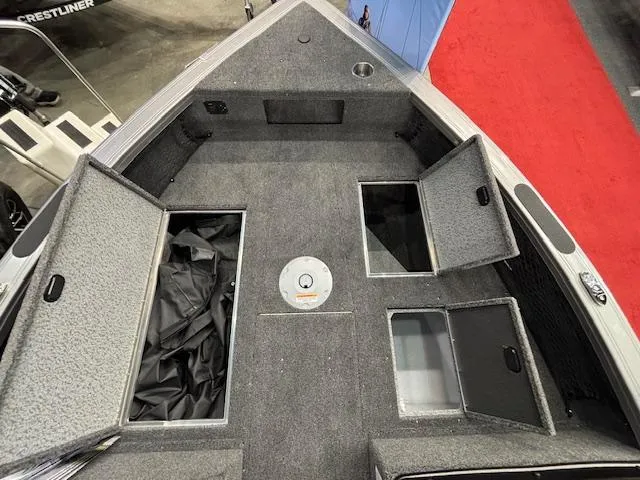 Slide: The Image of 2025 Crestliner 1850 Fish Hawk WT JS boat interior with open storage compartments. - 15