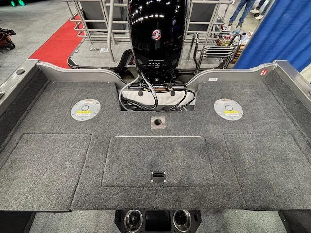 Slide: The Image of 2025 Crestliner 1850 Fish Hawk WT JS boat interior with motor and carpeted deck. - 19