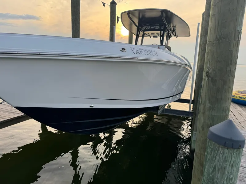 Slide: The Image of 2018 Statement 35 CC boat docked at sunset, reflecting on calm water. - 10