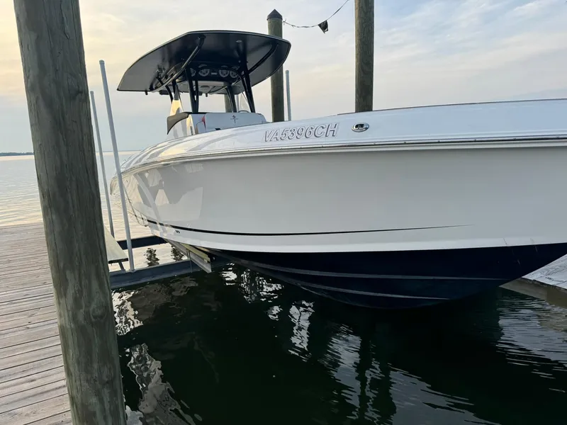 Slide: The Image of 2018 Statement 35 CC boat docked on calm water at sunset. - 11
