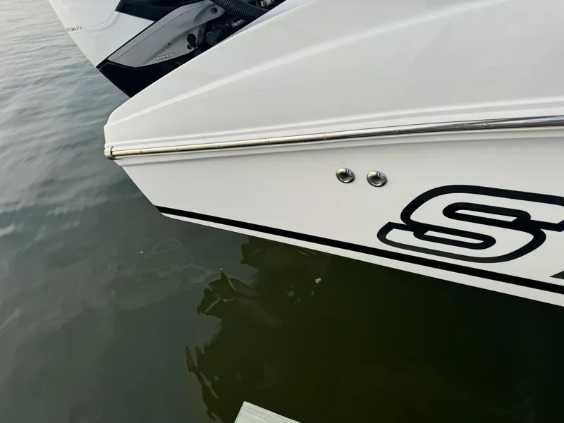 Slide: The Image of Close-up of a 2018 Statement 35 CC boat's sleek white hull on water. - 12