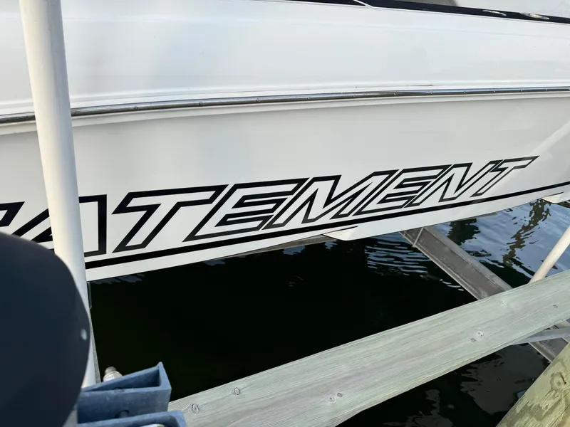 Slide: The Image of 2018 Statement 35 CC boat docked, showcasing bold lettering on the side. - 13