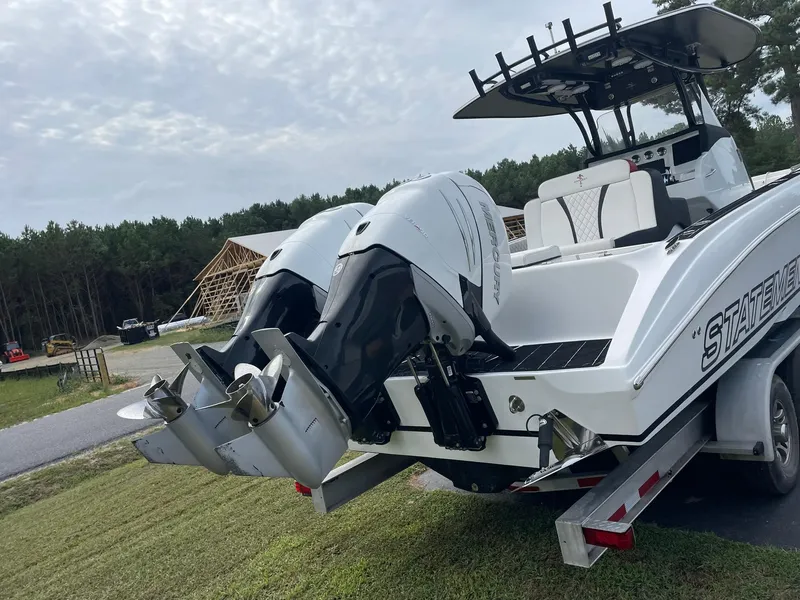Slide: The Image of 2018 Statement 35 CC boat with dual outboard motors on a trailer. - 2