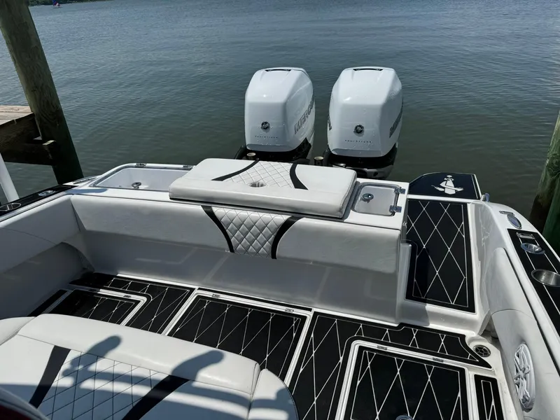 Slide: The Image of 2018 Statement 35 CC boat with dual outboard engines, featuring sleek black and white interior design. - 4