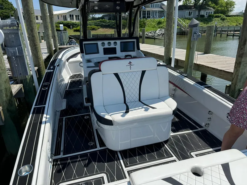 Slide: The Image of 2018 Statement 35 CC boat with luxurious seating and modern dashboard at a dock. - 5