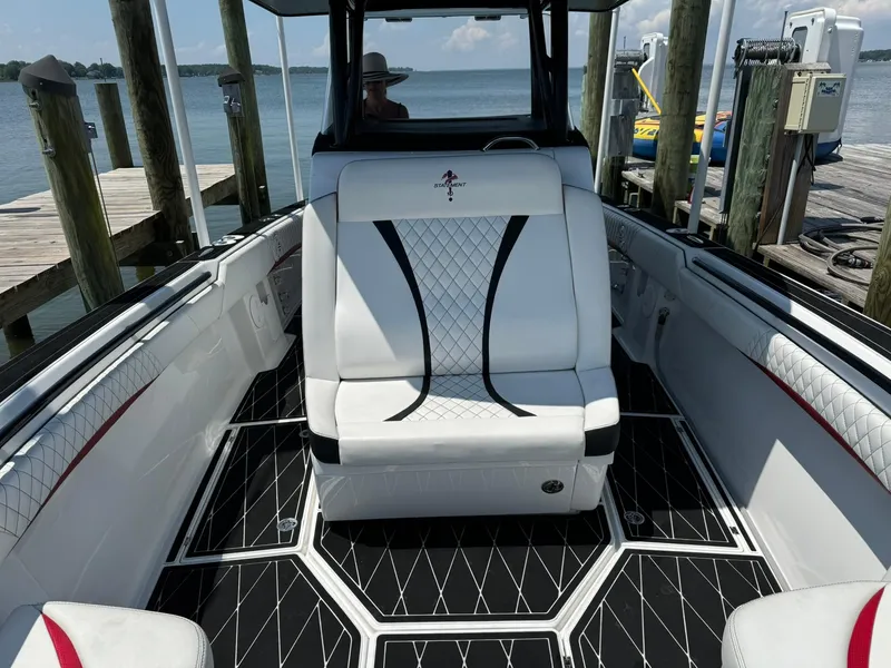 Slide: The Image of Luxurious 2018 Statement 35 CC boat interior with white seating and black accents at a dock. - 7