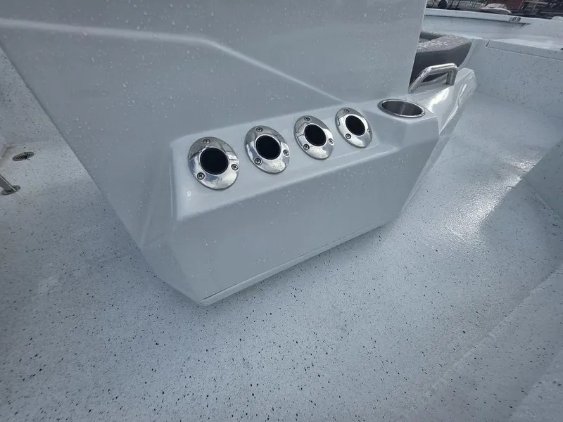 Slide: The Image of 2025 Xpress H22B boat interior with rod holders and cup holder. - 11