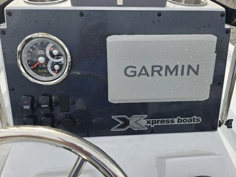 Slide: The Image of Dashboard of 2025 Xpress H22B boat with Garmin display and gauges. - 19
