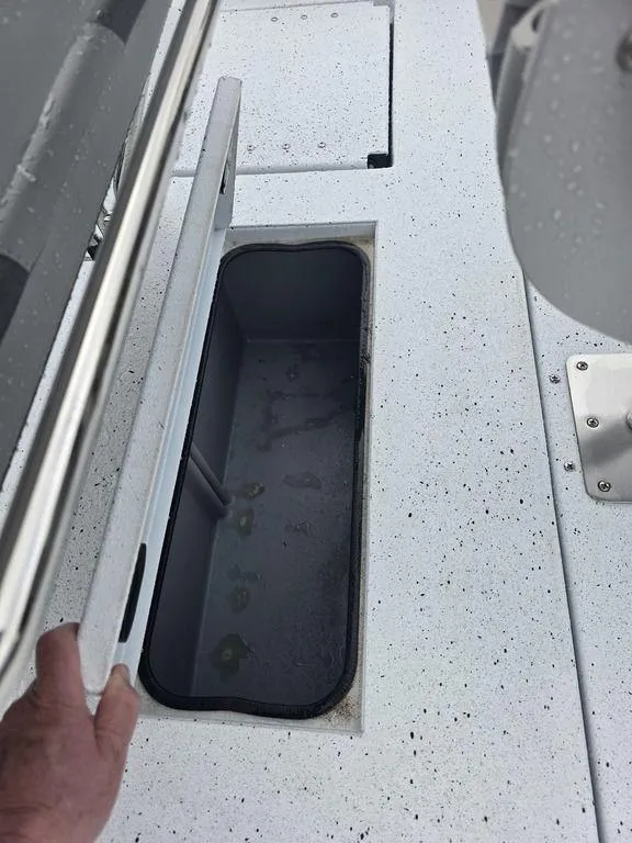 Slide: The Image of 2025 Xpress H22B boat storage compartment with open lid, showcasing interior space. - 22