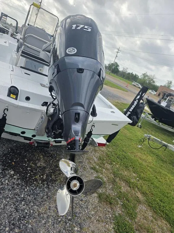 Slide: The Image of 2025 Xpress H22B boat with 175 horsepower outboard motor, parked on gravel. - 28