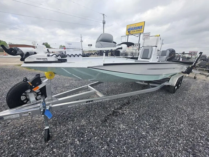 Slide: The Image of 2025 Xpress H22B boat on trailer, displayed outdoors at a marine dealership. - 5