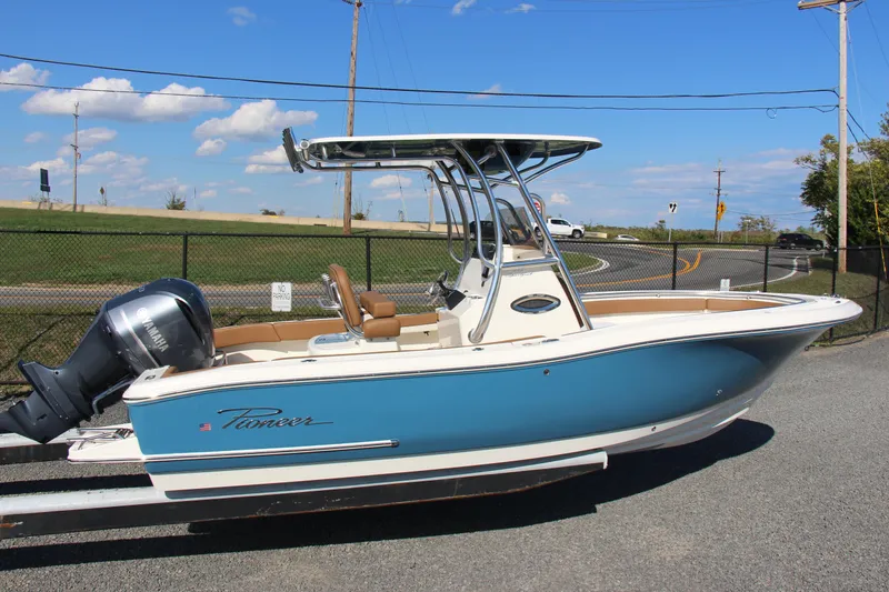 Slide: The Image of 2025 Pioneer 222 Sportfish boat with blue hull and T-top on a trailer. - 3
