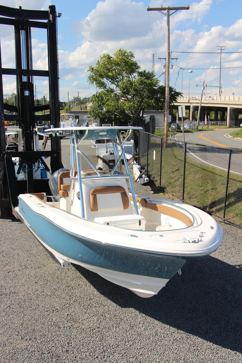 Slide: The Image of 2025 Pioneer 222 Sportfish boat on display, featuring sleek design and modern amenities. - 5