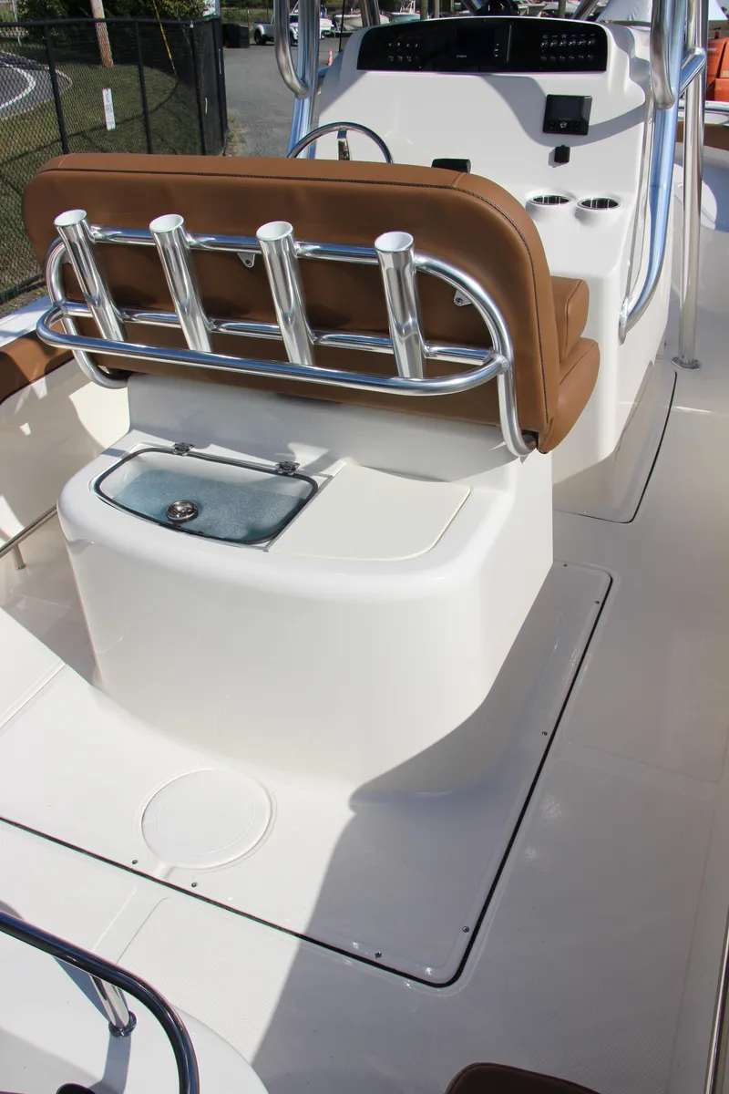 Slide: The Image of 2025 Pioneer 222 Sportfish boat interior with rod holders and seating. - 7