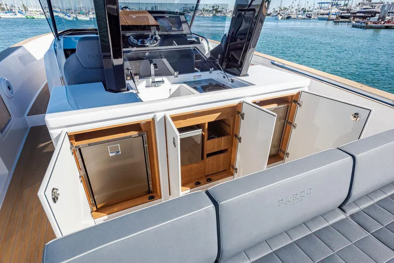 Slide: The Image of 2023 Pardo Yachts P38 interior with open cabinets, sleek design, and ocean backdrop. - 13