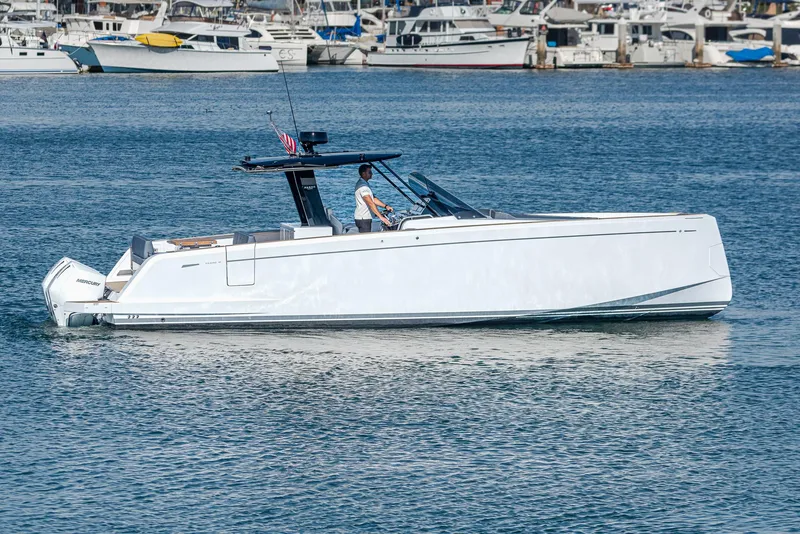 Slide: The Image of 2023 Pardo Yachts P38 cruising in a marina, surrounded by other boats. - 28