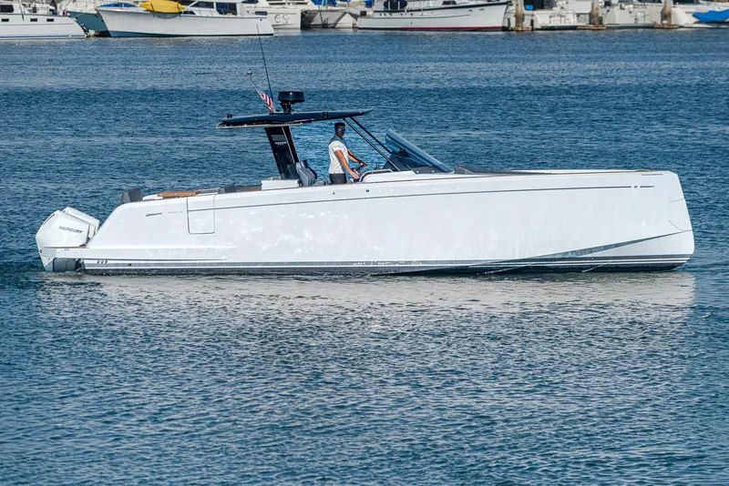 Slide: The Image of 2023 Pardo Yachts P38 cruising on calm waters near a marina. - 29
