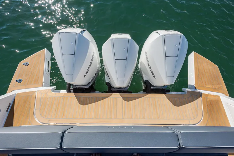 Slide: The Image of 2023 Pardo Yachts P38 with triple Mercury outboard engines on a wooden deck. - 8