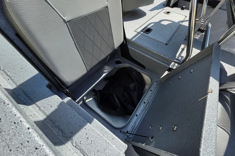 Slide: The Image of 2025 Xpress H20B Bay boat storage compartment with open lid, showcasing interior design. - 10