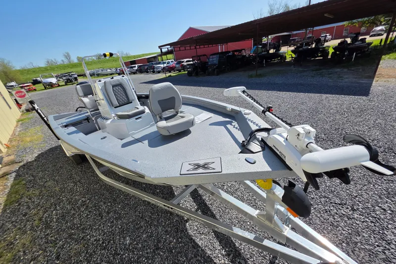 Slide: The Image of 2025 Xpress H20B Bay boat on trailer, featuring modern design and seating. - 12