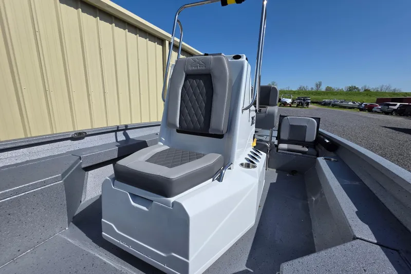 Slide: The Image of 2025 Xpress H20B Bay boat interior with gray seating and console. - 16