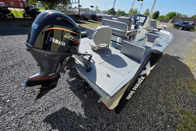 Slide: The Image of 2025 Xpress H20B Bay boat with Yamaha engine, parked on gravel. - 6