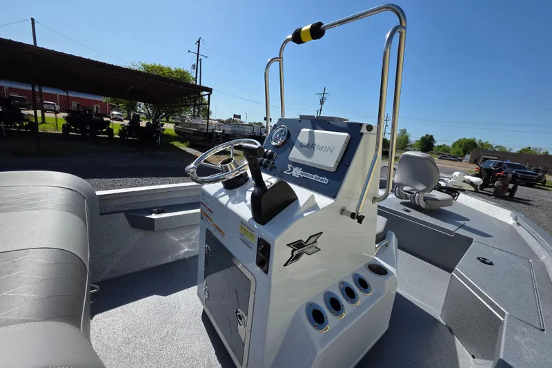 Slide: The Image of 2025 Xpress H20B Bay boat interior with Garmin navigation system and seating. - 7