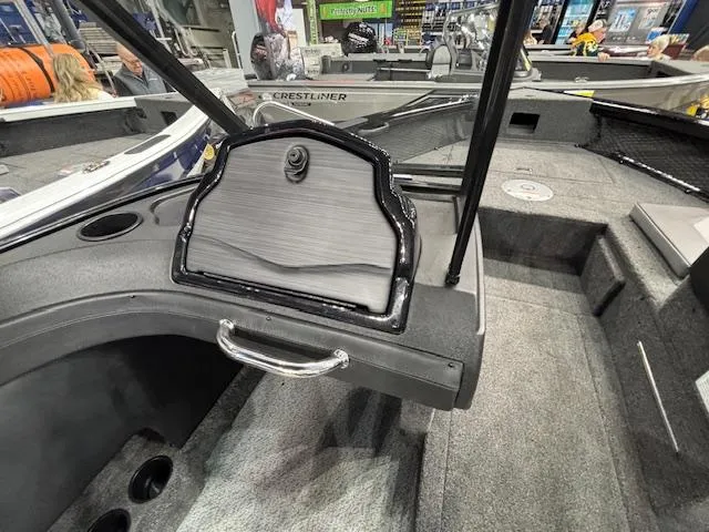 Slide: The Image of 2025 Crestliner 1850 Super Hawk WT JS boat interior with gray carpet and storage compartment. - 11