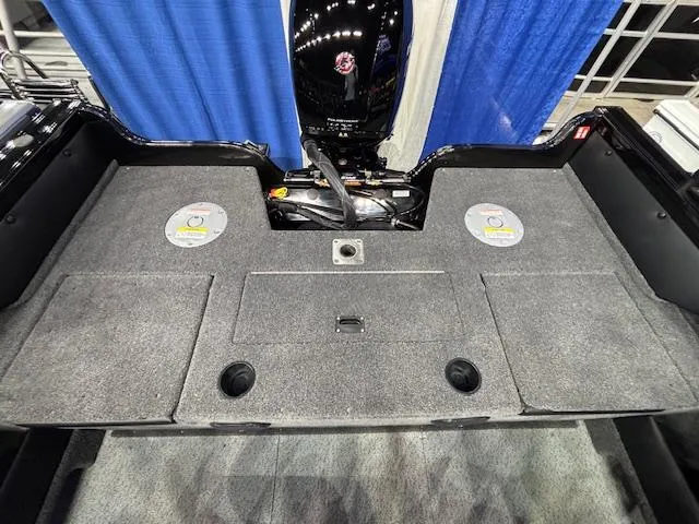 Slide: The Image of 2025 Crestliner 1850 Super Hawk WT JS boat interior with carpeted deck and motor. - 22