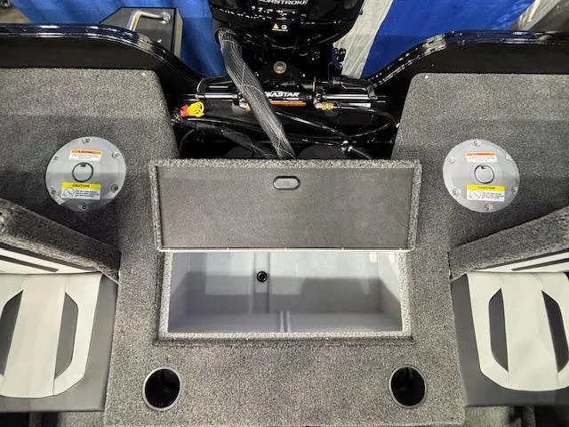 Slide: The Image of 2025 Crestliner 1850 Super Hawk WT JS boat interior with storage compartments and motor. - 24