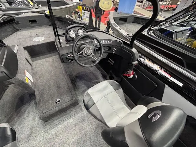 Slide: The Image of Interior of 2025 Crestliner 1850 Super Hawk WT JS boat, featuring steering wheel and seating. - 5