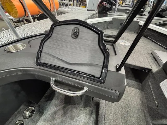 Slide: The Image of 2025 Crestliner 1750 Super Hawk WT JS boat interior with storage compartment and cup holder. - 11